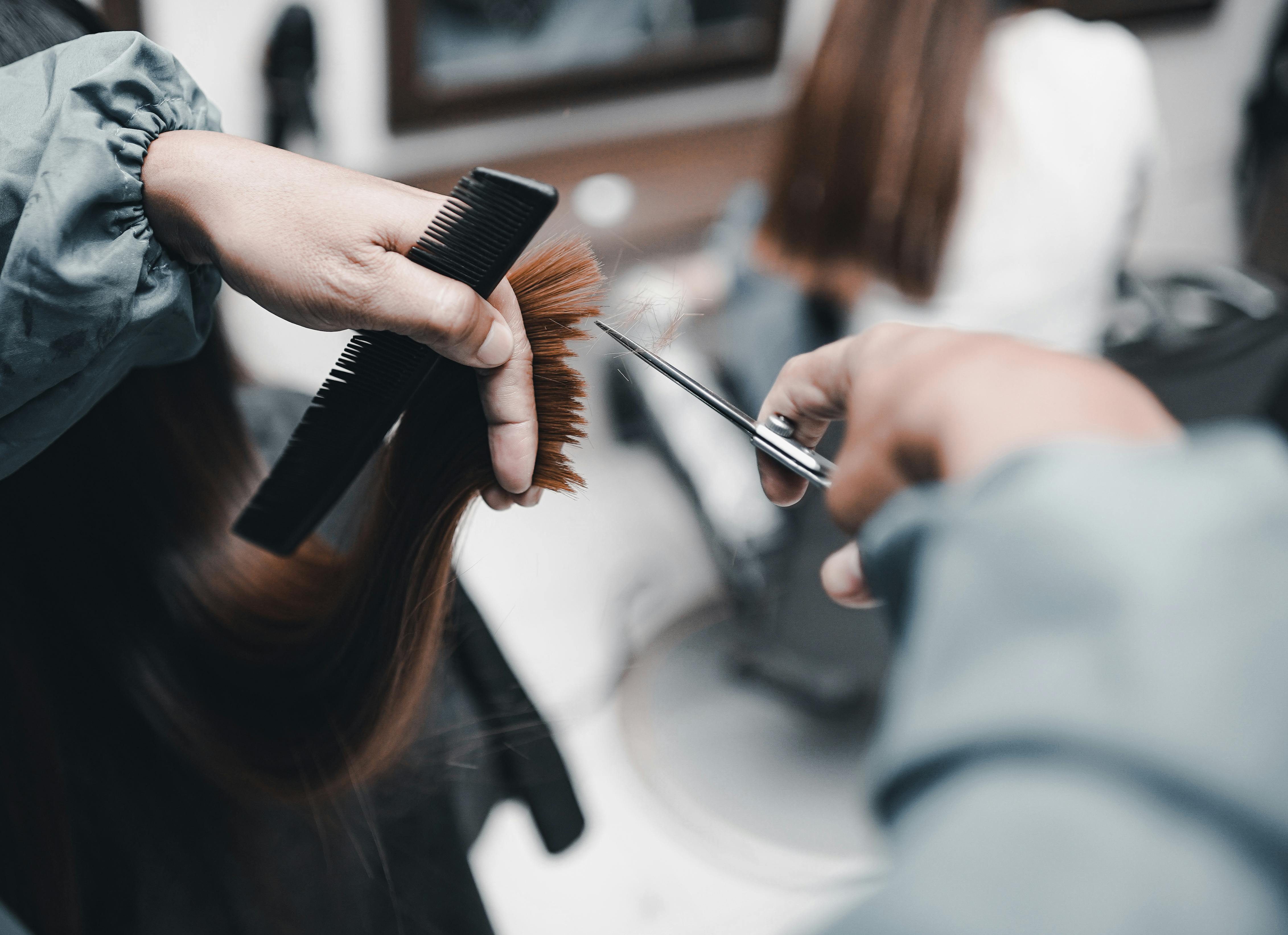 Barber carefully styling a client's hair